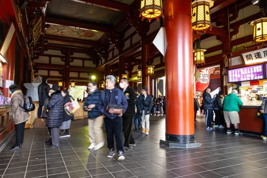 Tokyo, Japan. January 2024. the faithful at the Sensō-ji Buddhist temple main hall in the city center