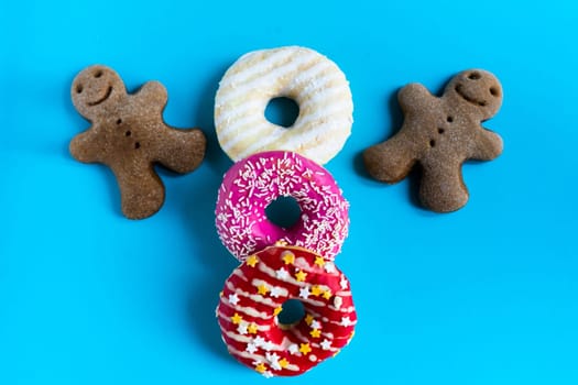 Donut with hazelnuts on a blue background, close up