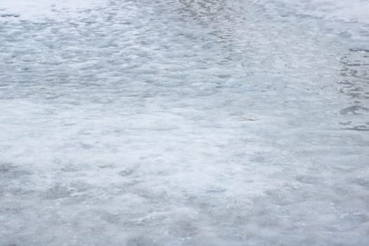 Ice on the footpath close up, background or texture