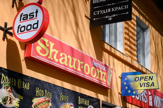 Ivano-Frankivsk, Ukraine March 26, 2023: Sign logo of a fast food restaurant on the street, an establishment where shawarma is prepared.
