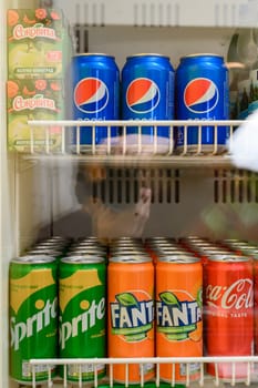 Ivano-Frankivsk, Ukraine March 26, 2023: Sprite, Fanta, Coca Cola and Pepsi drinks on the display of a refrigerator, cooling and carbonated drinks.