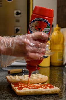 Ivano-Frankivsk, Ukraine March 26, 2023: the process of making a panini, a bun with mayonnaise and ketchup for a panini
