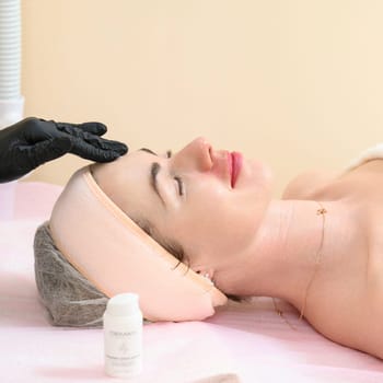 Ivano-Frankivsk, Ukraine May 17, 2023: Facial massage in a spa salon, a cosmetologist performs a relaxing procedure on a girl's face, anti-aging massage