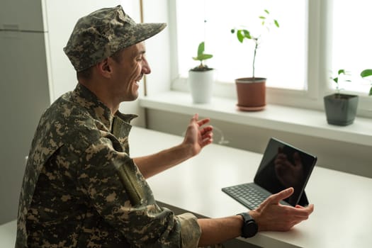 Caucasian soldier in army uniform in front of computer feeling happy and excited. American soldier receiving good news. High quality photo