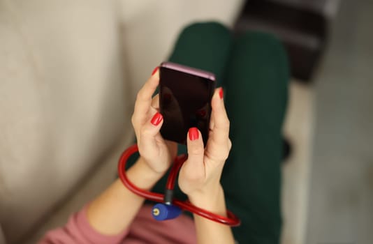 Female hands with lock hold smartphone. Addiction to modern gadgets concept