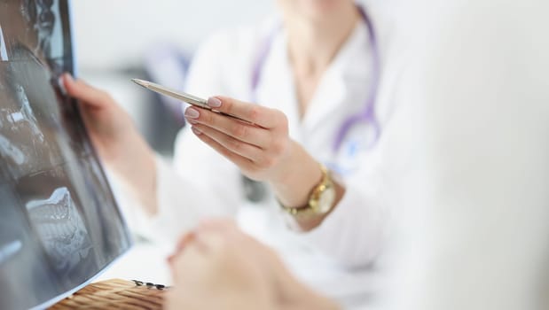 Doctor shows X-ray to patient. Magnetic resonance imaging concept