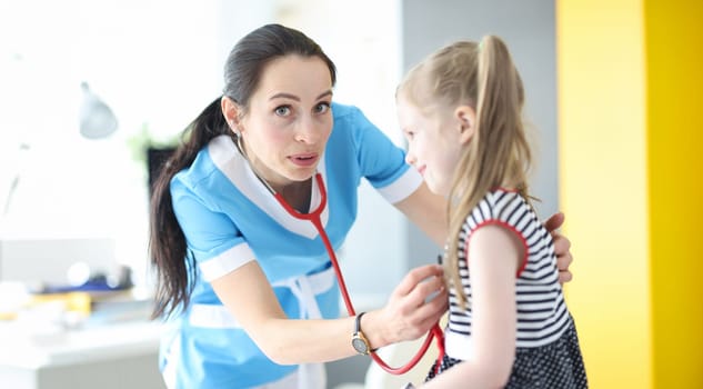 Doctor pediatrician forgot to put stethoscope in her ears. First day of work as doctor concept