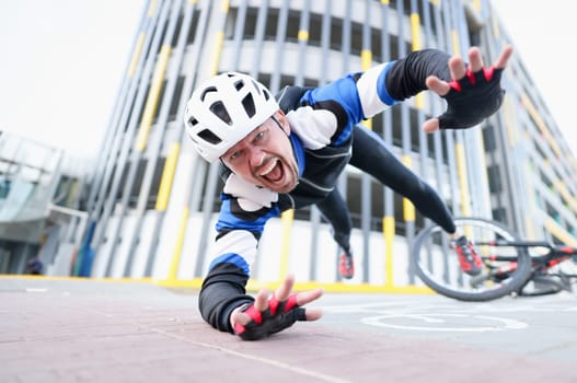 Young male cyclist wearing helmet and protective gear fell off bike and flying portrait. Accident insurance concept