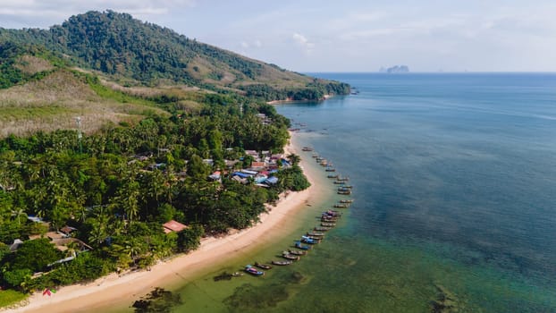 A beautiful view of a calm beach with crystal clear water on the blue sky at Koh Libong, Trang province, Thailand, Andaman Sea.