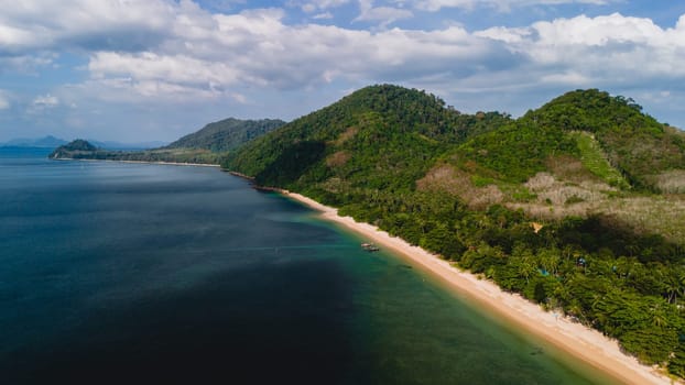 A beautiful view of a calm beach with crystal clear water on the blue sky at Koh Libong, Trang province, Thailand, Andaman Sea.