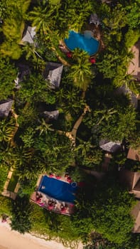 aerial drone view of a swimming pool in the jungle rainforest in Thailand, aerial view with a drone above a swimming pool in the rainforest of Thailand.