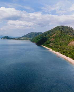 A beautiful view of a calm beach with crystal clear water on the blue sky at Koh Libong, Trang province, ThailandmAndaman Sea in the afternoon light