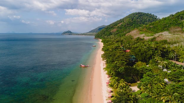 A beautiful view of a calm beach with crystal clear water on the blue sky at Koh Libong, Trang province, ThailandmAndaman Sea in the afternoon light