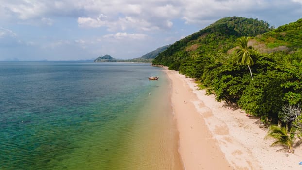 A beautiful view of a calm beach with crystal clear water on the blue sky at Koh Libong, Trang province, ThailandmAndaman Sea in the afternoon light