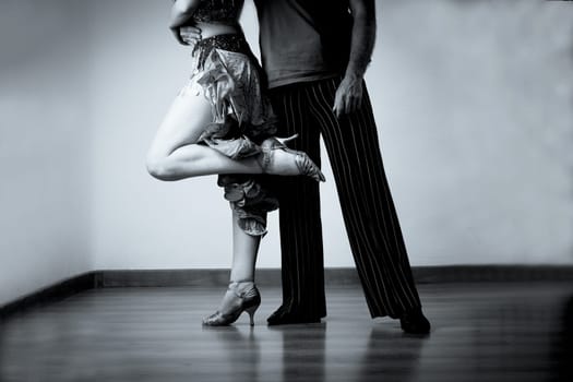 Legs of man and woman in dancing position. Latin dance