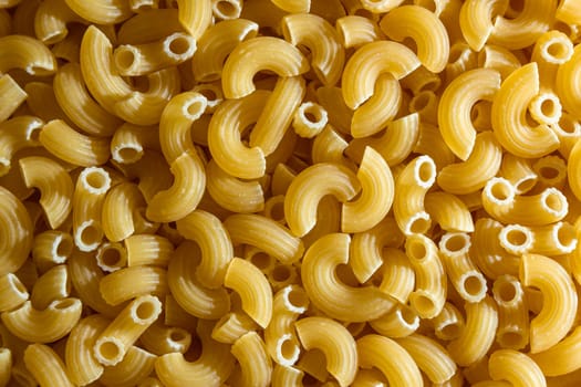 Uncooked Chifferi Rigati Pasta: A Culinary Canvas of Chifferi Rigati, Creating a Lively and Textured Background for Gourmet Cooking. Dry Pasta. Raw Macaroni - Top View, Flat Lay