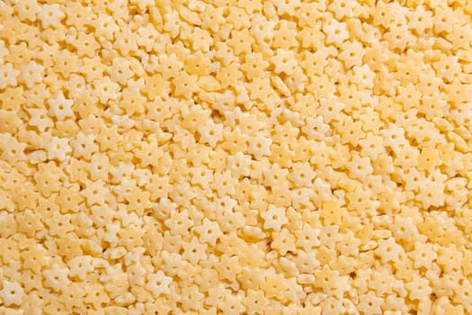 Uncooked Stelline Pasta: A Culinary Canvas of Stelline Macaroni, Creating a Lively and Textured Background for Gourmet Cooking. Dry Pasta. Raw Macaroni - Top View, Flat Lay