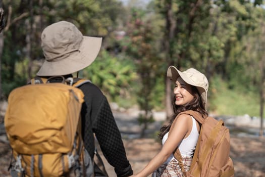 Lovely couple lesbian woman with backpack hiking in nature. Loving LGBT romantic moment in mountains.