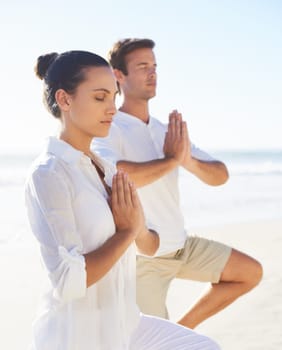 Yoga, meditation and travel with couple on beach together for wellness, zen or holistic exercise. Summer, awareness or mindfulness with young man and woman by sea or ocean for balance and inner peace.
