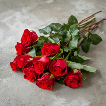 A bouquet of beautiful red roses lies on a light surface. AI generated.