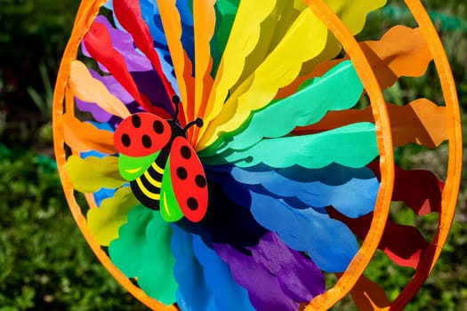 spinner toy , Big round rainbow pinwheel in motion.
