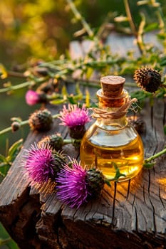 Milk thistle oil on a table in the garden. Selective focus. Food.