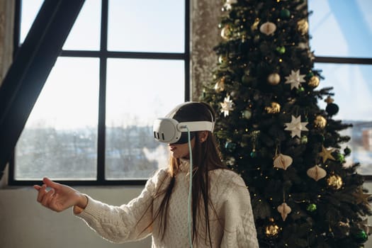 A sunny winter morning setting: a bright young woman with a virtual reality headset. High quality photo