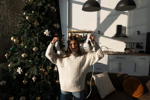 A cheerful young lady was given a virtual reality headset as a Christmas present. High quality photo