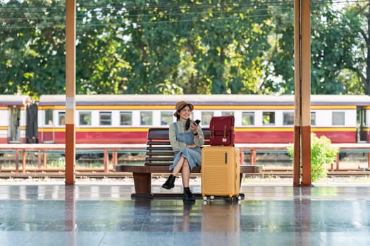 Woman using mobile phone while travel by train. travel concept.