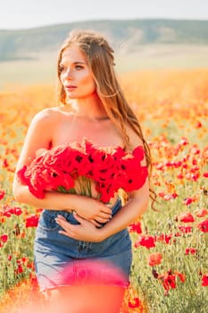 Woman poppies field. portrait of a happy woman with long hair in a poppy field and enjoying the beauty of nature in a warm summer day