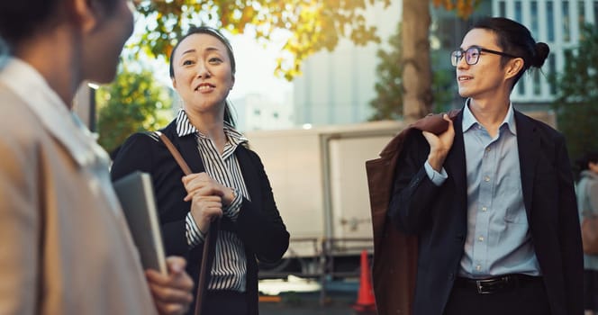 Meeting, conversation and business people in the city talking for communication or bonding. Smile, discussion and professional Asian colleagues speaking and laughing together commuting in town