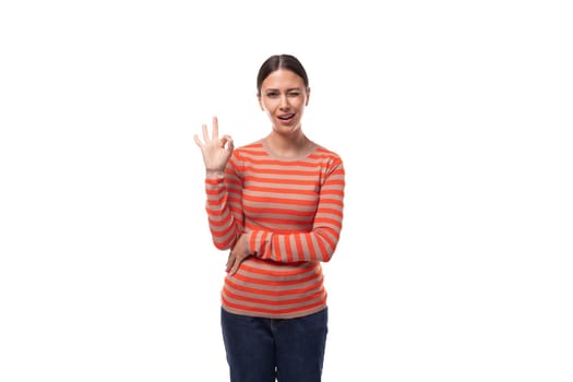 young european slim woman dressed in casual clothes shows ok gesture on white background.