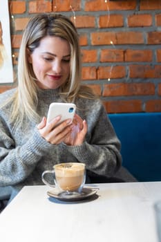 Girl with long hair drinks coffee latte . High quality photo