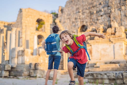 dad and son tourists at the ruins of ancient city of Perge near Antalya Turkey. Traveling with kids concept.