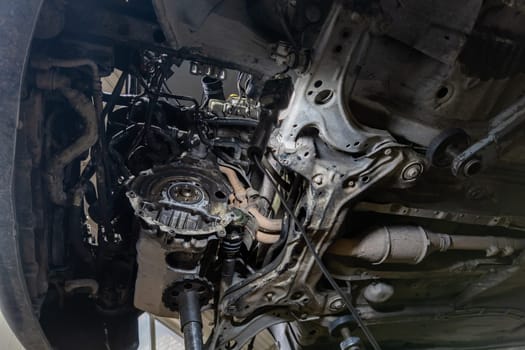 old German car engine bay with dismounted gearbox, view from below.