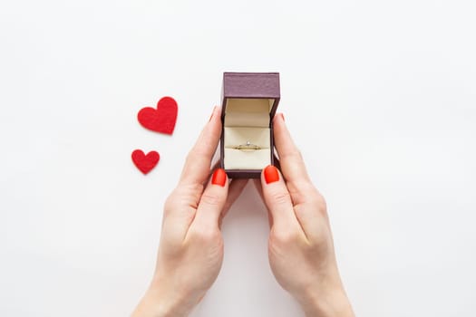 girl holding a box with a ring with a diamond in her hands. Marriage proposals