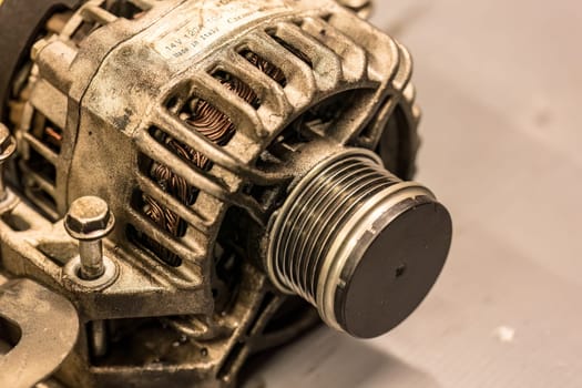 A close-up photo showcasing the detailed structure of an alternator pulley in a car engine.