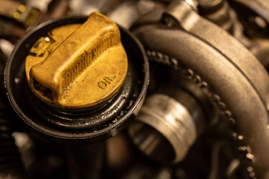 Photo shows a dirty oil cap on a car engine, symbolizing the urgent need for vehicle maintenance.