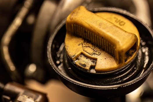 Photo shows a dirty oil cap on a car engine, symbolizing the urgent need for vehicle maintenance.