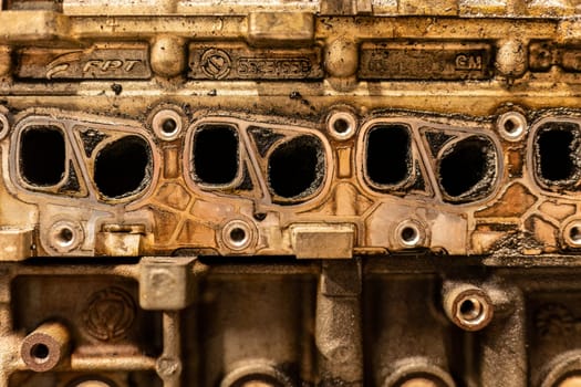 A photo showing dirty intake manifolds in a car engine, impacted by exhaust gas recirculation (EGR) effects.