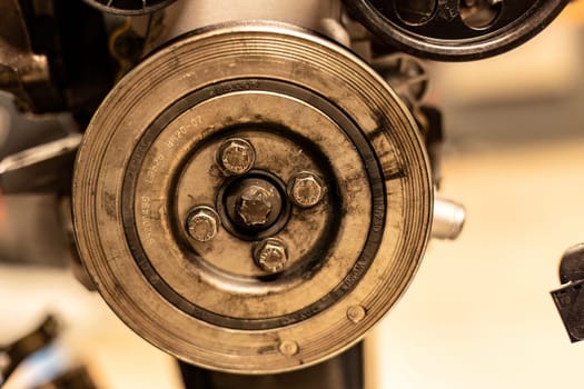 Photo focusing on the intricate pulleys of a car engine, highlighting their essential role in function.