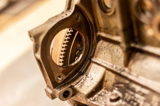 Close-up photo capturing the intricate details of a flywheel in a car engine, a key mechanical component.