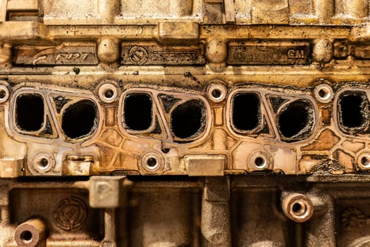 A photo showing dirty intake manifolds in a car engine, impacted by exhaust gas recirculation (EGR) effects.