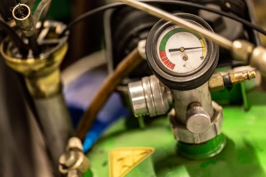 Photo of an oil pressure gauge in a workshop, a crucial tool for monitoring engine health.