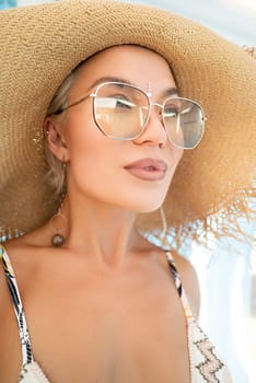 sexy young girl in a straw hat on vacation smiles, gets high and enjoys life in the summer