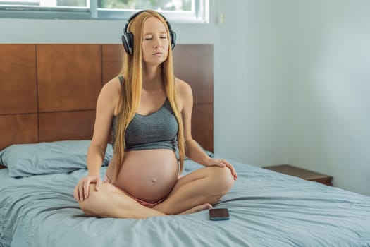 Expectant woman finds serenity in pregnancy, listening to affirmations and meditating for calmness.