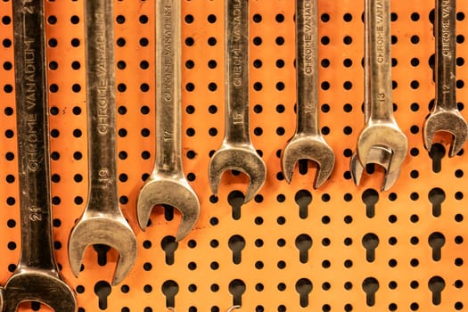 Rome, Italy 17 january 2024: A well-organized display of various wrenches hanging neatly on a workshop tool panel.