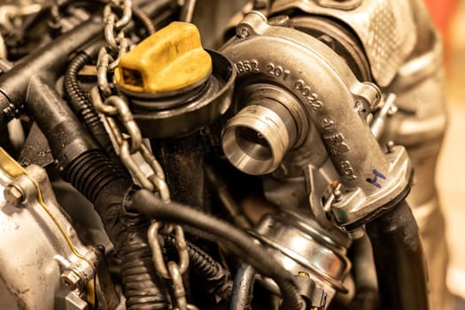 Rome, Italy 17 january 2024: Photo focuses on the detailed aspects of a turbine in a car engine during a maintenance check.