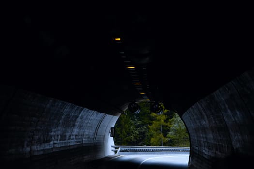 Emerging from Darkness: The Enigmatic Journey Through a Tunnel with Light at the End. High quality photo