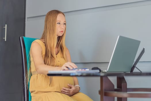 Beautiful pregnant woman working on laptop. Young businesswoman working in her office.